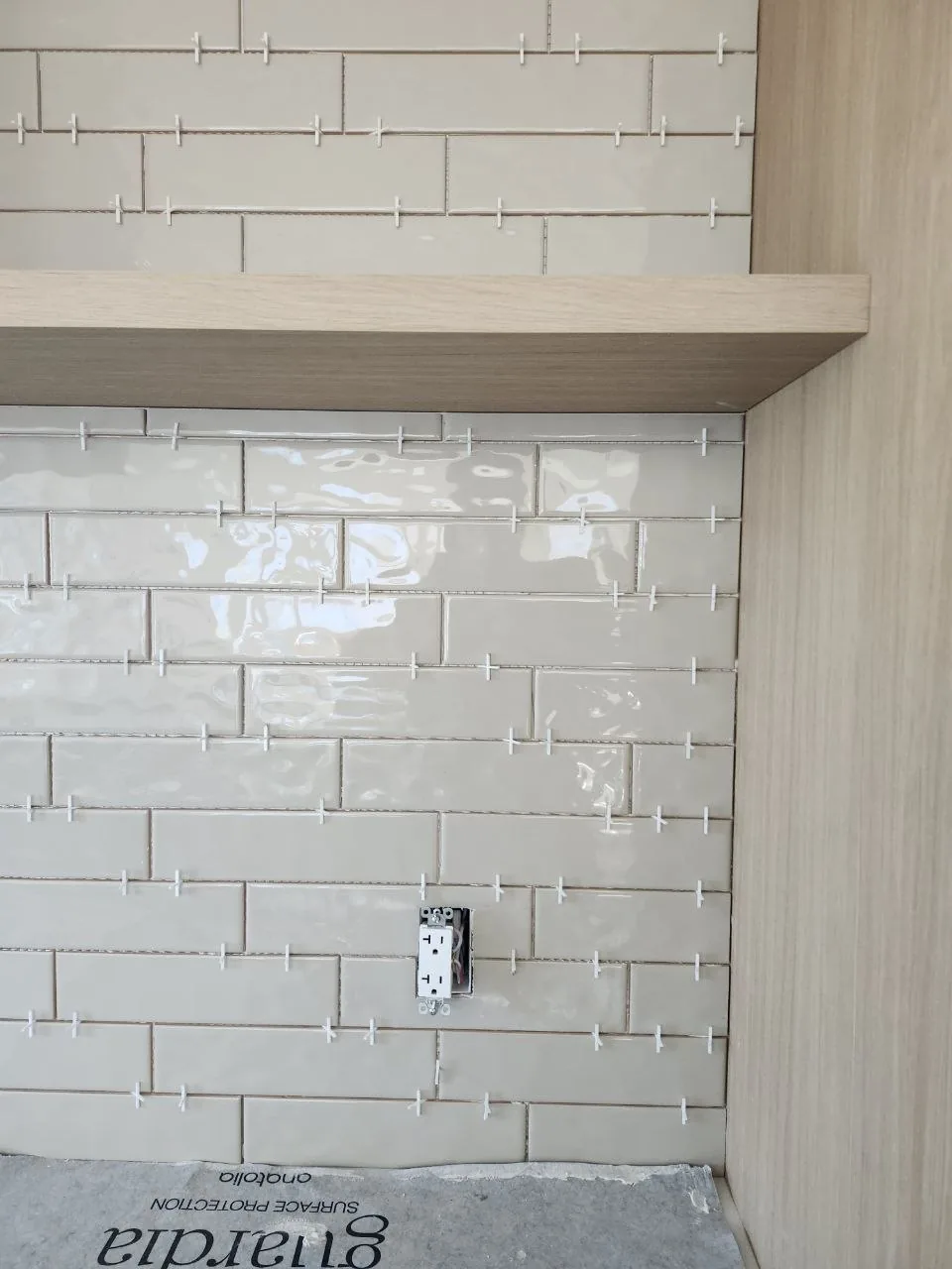 Offset linear tile layout with leveling spacers