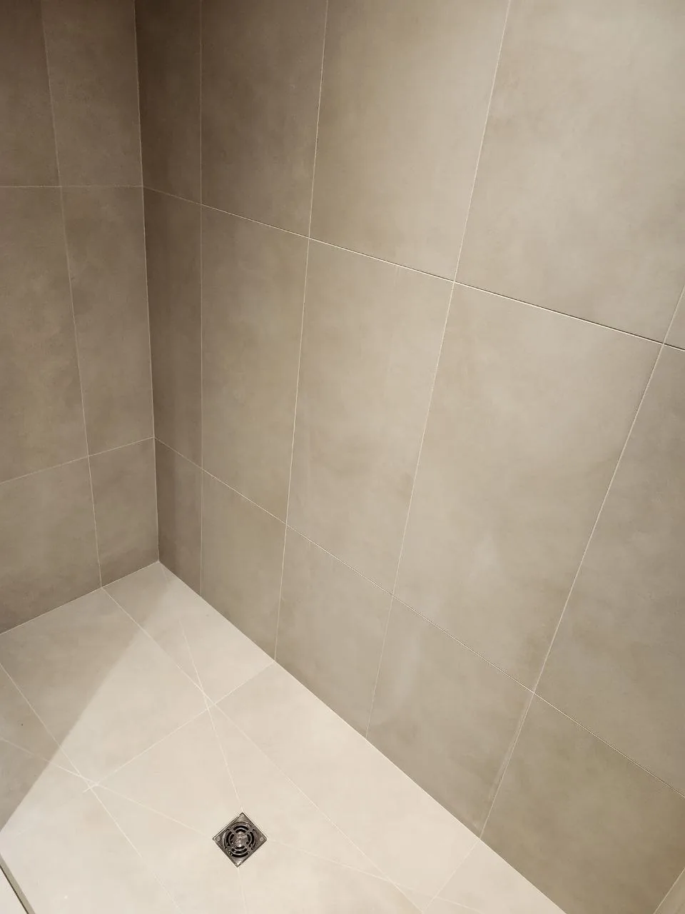 Large-format greige porcelain shower