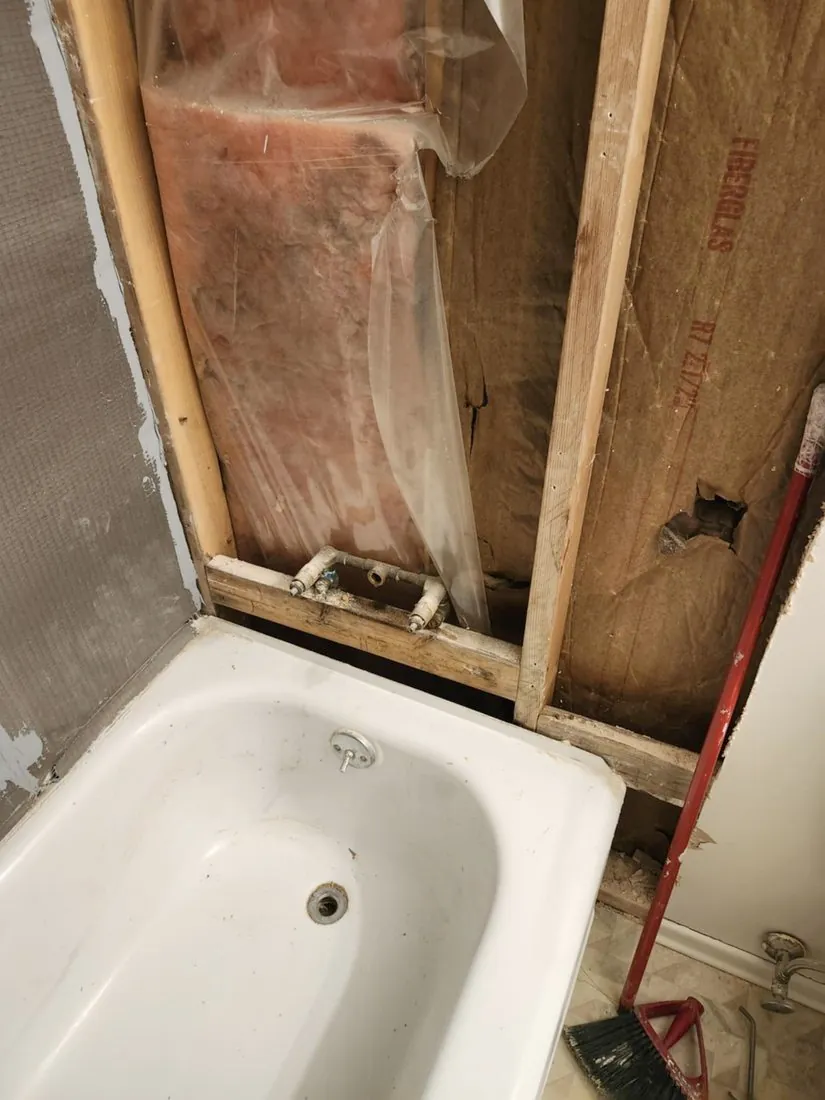 Old plumbing & framing exposed