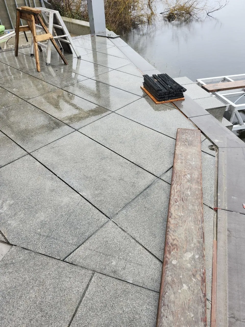 Setting pavers at the water's edge