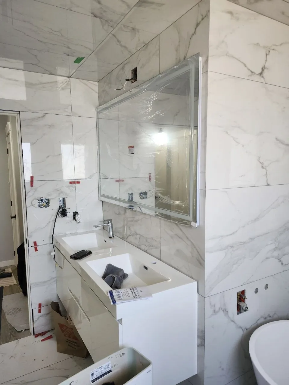 Vanity and mirror going in