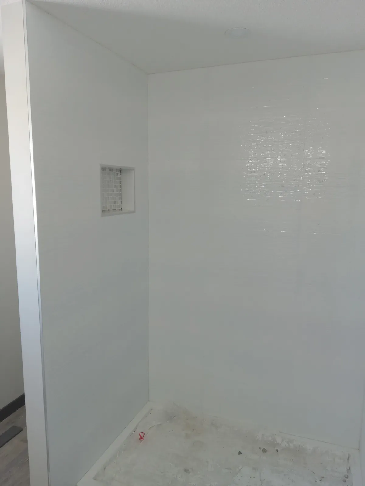 Bright white textured-tile shower