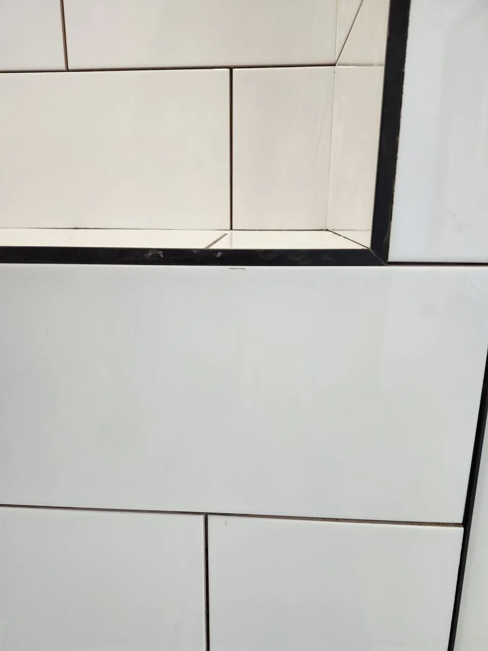 Full-height white subway walls